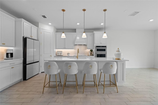 17571 Saw Palmeto Ave, Clermont, FL 34714 - kitchen with appliances with stainless steel finishes, decorative backsplash, light countertops, a breakfast bar, and recessed lighting