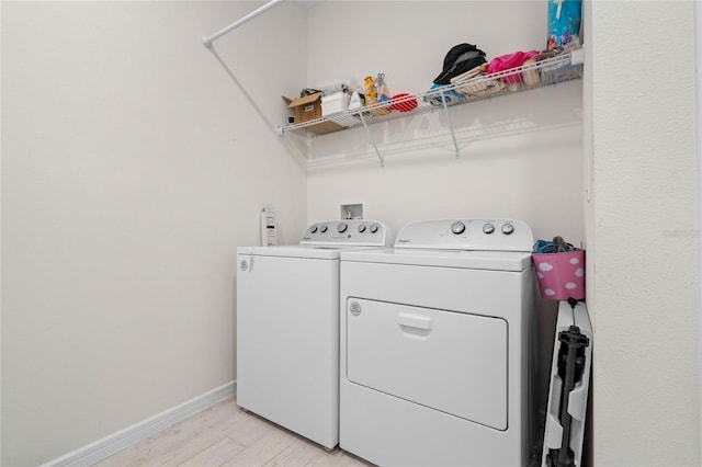 17571 Saw Palmeto Ave, Clermont, FL 34714 - laundry room with washing machine and dryer and light wood-style flooring