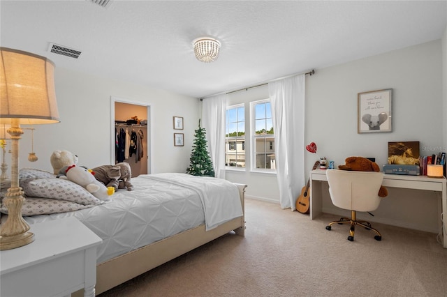 17571 Saw Palmeto Ave, Clermont, FL 34714 - bedroom with light carpet, an office area, and a spacious closet
