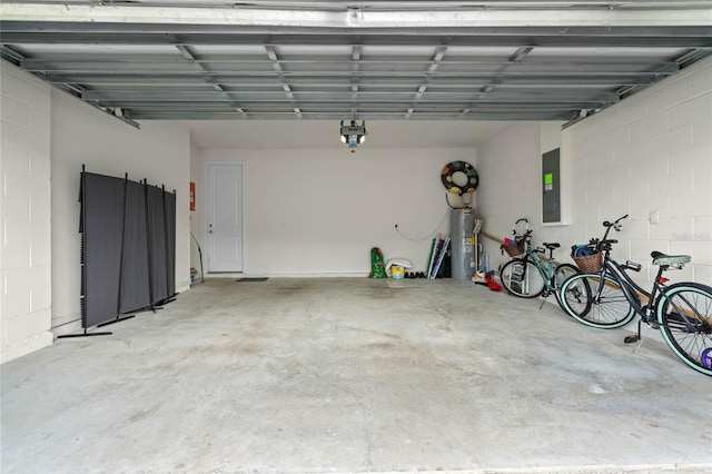 17571 Saw Palmeto Ave, Clermont, FL 34714 - garage featuring water heater, electric panel, concrete block wall, and a garage door opener