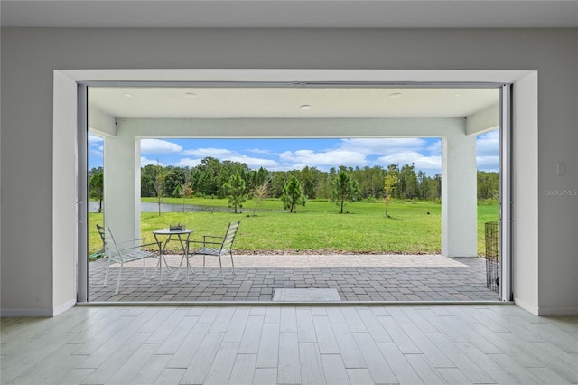 17571 Saw Palmeto Ave, Clermont, FL 34714 - doorway to outside featuring wood finished floors and a water view
