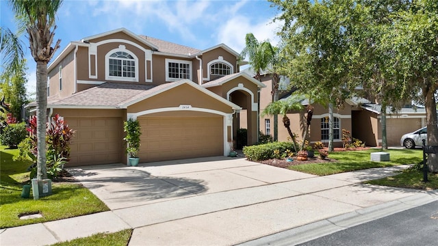 2454 Black Lake Blvd, Winter Garden, FL 34787 - traditional home with stucco siding, driveway, a garage, and a front yard