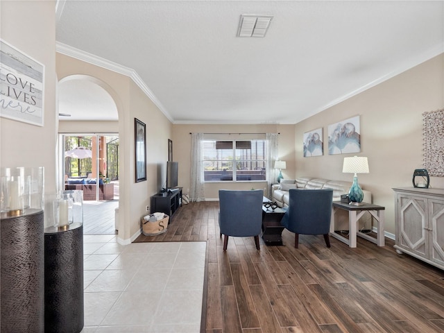 2454 Black Lake Blvd, Winter Garden, FL 34787 - dining room featuring arched walkways, ornamental molding, and wood finished floors