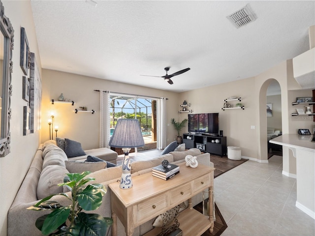 2454 Black Lake Blvd, Winter Garden, FL 34787 - living area featuring arched walkways, ceiling fan, and light tile patterned flooring