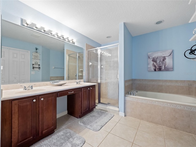 2454 Black Lake Blvd, Winter Garden, FL 34787 - bathroom with double vanity, a shower stall, tile patterned flooring, a bath, and a textured ceiling