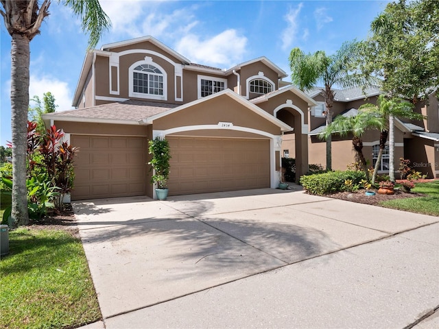 2454 Black Lake Blvd, Winter Garden, FL 34787 - view of front of home featuring an attached garage, stucco siding, and driveway