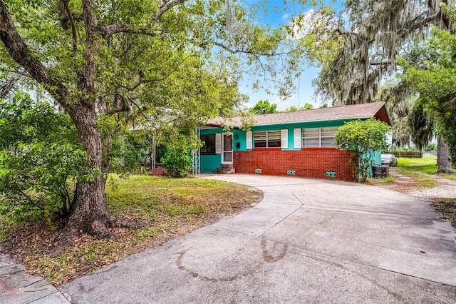 770 W Webster Ave, Winter Park, FL 32789 - view of front of house featuring driveway and brick siding