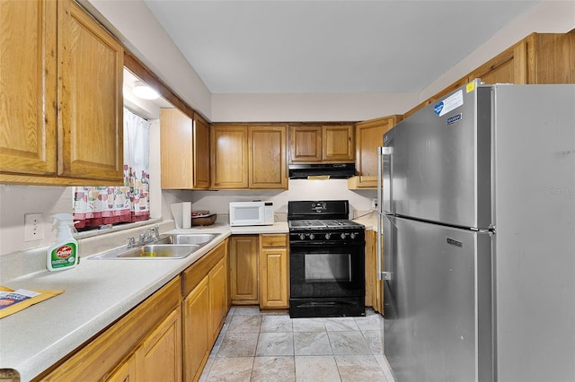 770 W Webster Ave, Winter Park, FL 32789 - kitchen featuring freestanding refrigerator, black range with gas stovetop, white microwave, under cabinet range hood, and light countertops