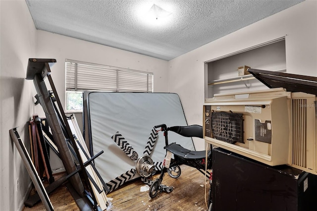 770 W Webster Ave, Winter Park, FL 32789 - exercise room with a textured ceiling and hardwood / wood-style flooring