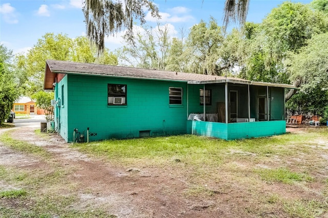 770 W Webster Ave, Winter Park, FL 32789 - rear view of house with a sunroom, concrete block siding, cooling unit, and a shingled roof