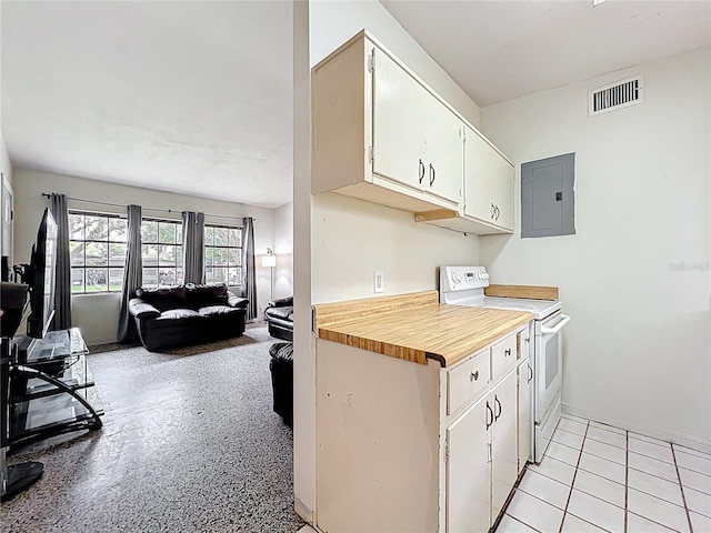 131 E 3rd Ct, Chuluota, FL 32766 - kitchen with electric range, electric panel, open floor plan, and white cabinetry