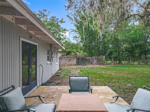 131 E 3rd Ct, Chuluota, FL 32766 - fenced backyard featuring french doors and a patio area