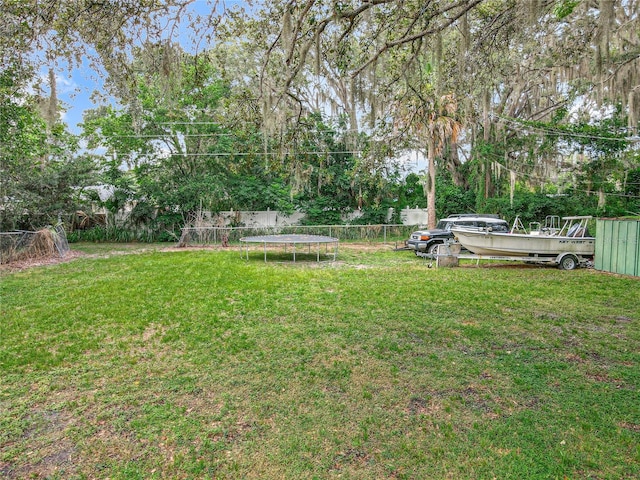 131 E 3rd Ct, Chuluota, FL 32766 - fenced backyard with a trampoline