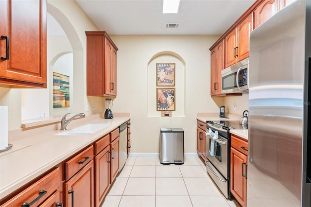 4024 Breakview Dr Unit 402, Orlando, FL 32819 - kitchen featuring stainless steel appliances, light countertops, and brown cabinets