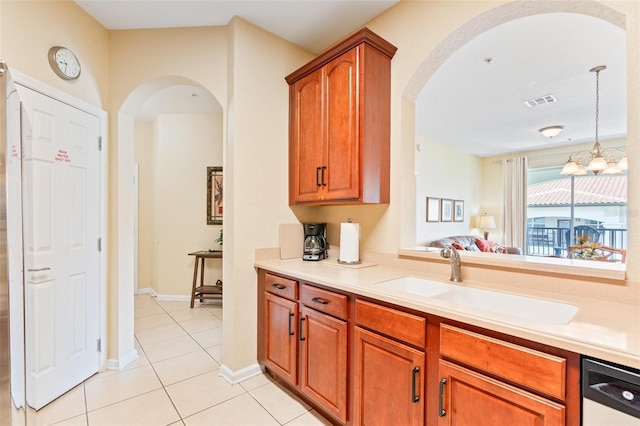 4024 Breakview Dr Unit 402, Orlando, FL 32819 - kitchen with arched walkways, light tile patterned floors, light countertops, and brown cabinetry