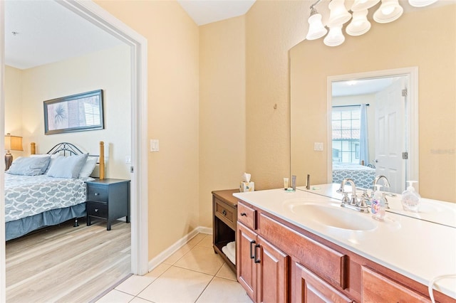 4024 Breakview Dr Unit 402, Orlando, FL 32819 - ensuite bathroom featuring vanity, tile patterned floors, and a chandelier