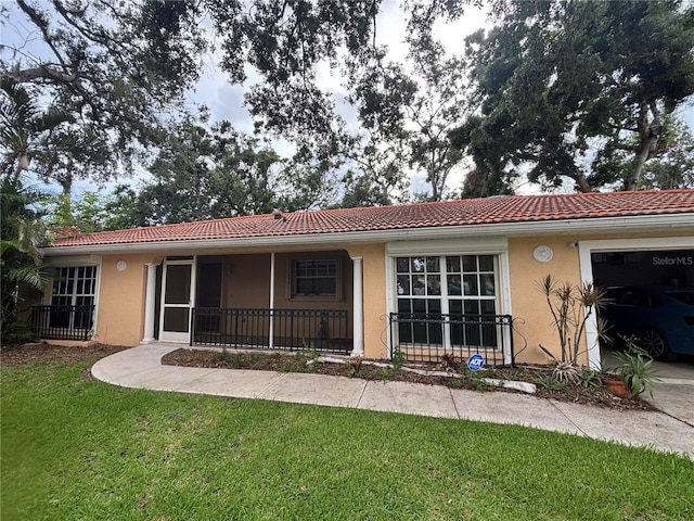 131 49th Ct E, Palmetto, FL 34221 - view of front of house with stucco siding, a tile roof, a front lawn, and a garage