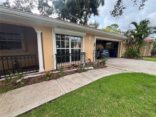 131 49th Ct E, Palmetto, FL 34221 - view of front of home with stucco siding, driveway, a front lawn, and an attached garage