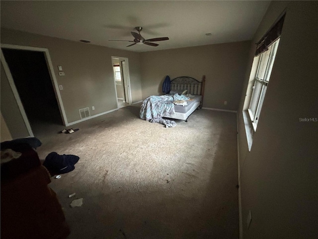 131 49th Ct E, Palmetto, FL 34221 - carpeted bedroom with multiple windows and a ceiling fan