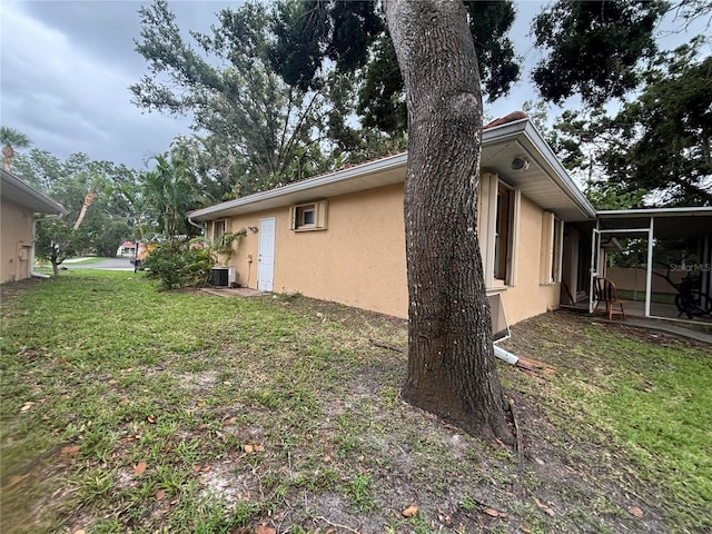 131 49th Ct E, Palmetto, FL 34221 - view of home's exterior with stucco siding and a yard