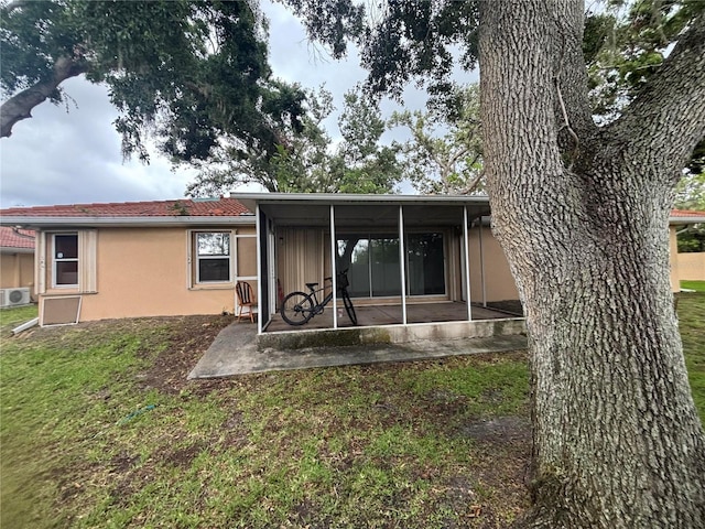 131 49th Ct E, Palmetto, FL 34221 - back of property with a patio area, stucco siding, and a lawn