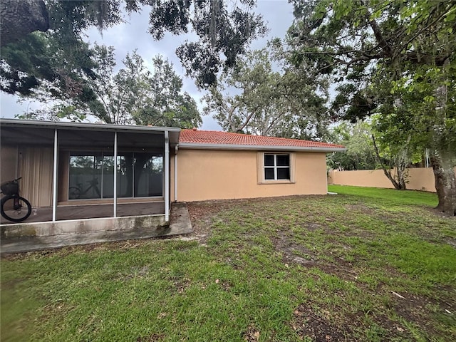 131 49th Ct E, Palmetto, FL 34221 - view of side of property with a sunroom, a tiled roof, and stucco siding