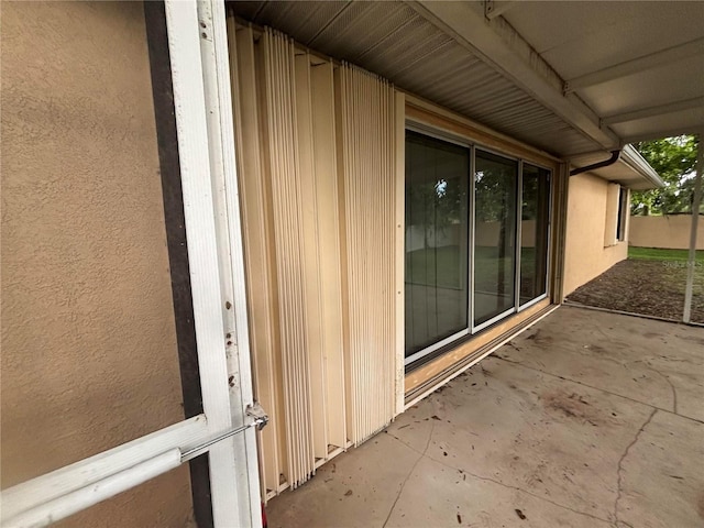 131 49th Ct E, Palmetto, FL 34221 - entrance to property with stucco siding and a patio area