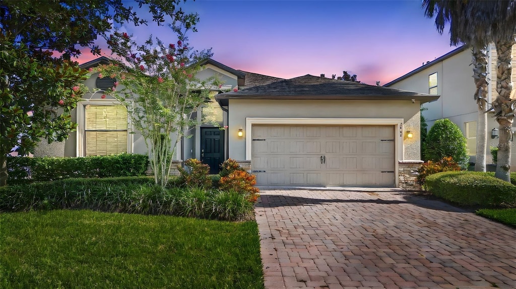 2008 Curia Rd, Winter Garden, FL 34787 - single story home with decorative driveway, an attached garage, stucco siding, and stone siding