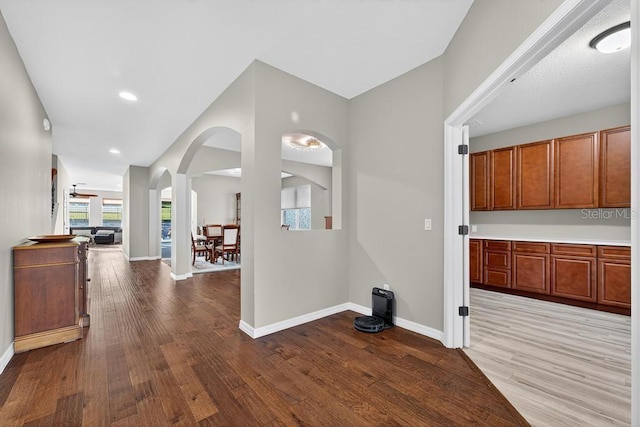30120 Hackney Loop, Mount Dora, FL 32757 - corridor featuring arched walkways, wood finished floors, and recessed lighting