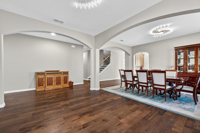 30120 Hackney Loop, Mount Dora, FL 32757 - dining room with wood finished floors, arched walkways, and stairway