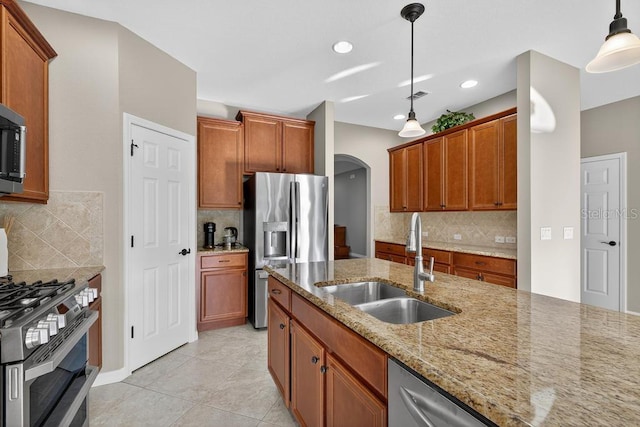 30120 Hackney Loop, Mount Dora, FL 32757 - kitchen with stainless steel appliances, arched walkways, decorative backsplash, light stone countertops, and pendant lighting