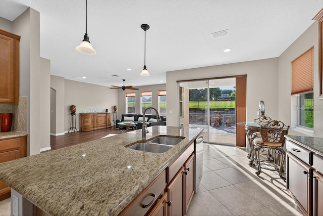 30120 Hackney Loop, Mount Dora, FL 32757 - kitchen featuring stainless steel dishwasher, decorative light fixtures, recessed lighting, a ceiling fan, and brown cabinetry