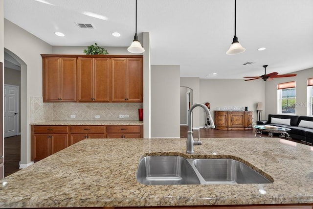 30120 Hackney Loop, Mount Dora, FL 32757 - kitchen featuring arched walkways, open floor plan, ceiling fan, light stone countertops, and recessed lighting