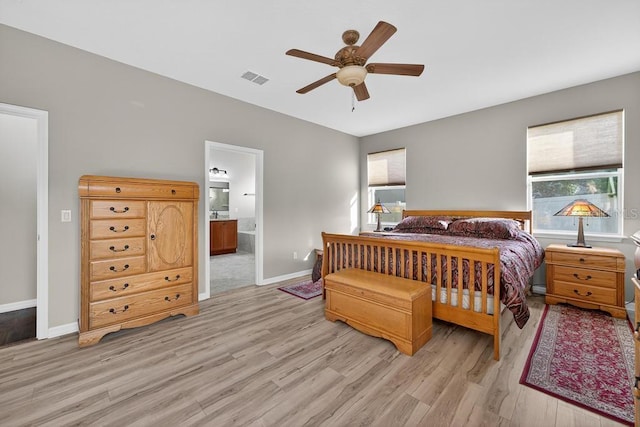 30120 Hackney Loop, Mount Dora, FL 32757 - bedroom featuring multiple windows, light wood-type flooring, ensuite bath, and a ceiling fan