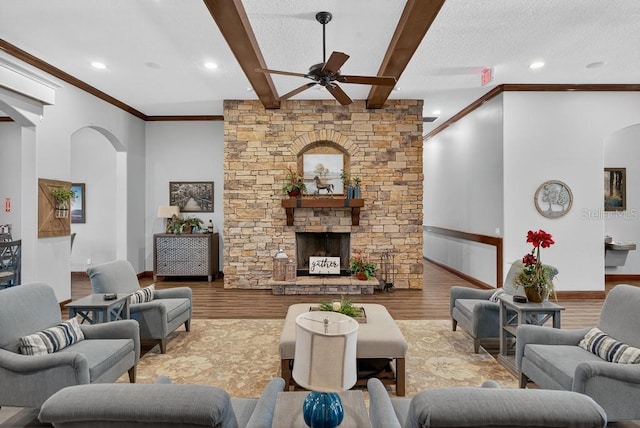 30120 Hackney Loop, Mount Dora, FL 32757 - living area with arched walkways, ceiling fan, wood finished floors, beamed ceiling, and crown molding