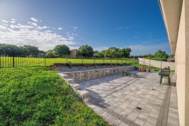 30120 Hackney Loop, Mount Dora, FL 32757 - fenced backyard with area for grilling and a patio