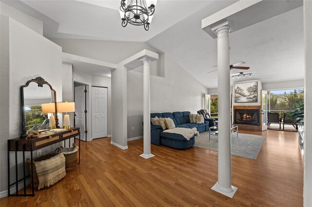 5949 Broken Bow Ln, Port Orange, FL 32127 - foyer with decorative columns, ceiling fan, a warm lit fireplace, lofted ceiling, and wood finished floors
