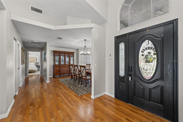 5949 Broken Bow Ln, Port Orange, FL 32127 - foyer entrance with wood finished floors and a chandelier