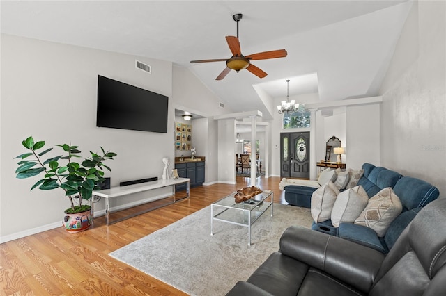 5949 Broken Bow Ln, Port Orange, FL 32127 - living room featuring a chandelier, wood finished floors, a ceiling fan, and vaulted ceiling