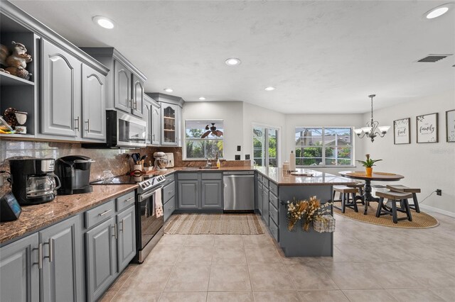 5949 Broken Bow Ln, Port Orange, FL 32127 - kitchen featuring gray cabinetry, stainless steel appliances, a peninsula, decorative backsplash, and recessed lighting