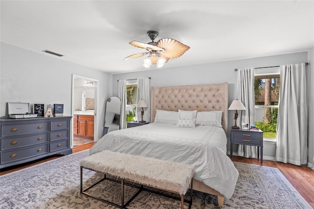 5949 Broken Bow Ln, Port Orange, FL 32127 - bedroom featuring wood finished floors, a ceiling fan, and connected bathroom