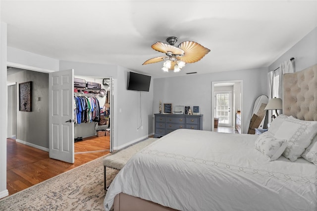 5949 Broken Bow Ln, Port Orange, FL 32127 - bedroom with wood finished floors, a ceiling fan, and a closet