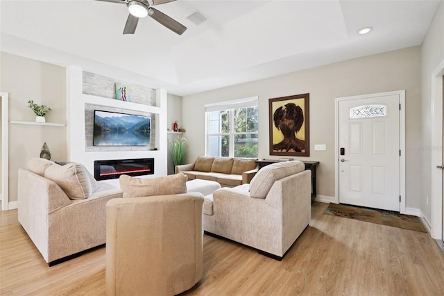 430 Baker Ave, Lake Helen, FL 32744 - living room with light wood-type flooring, a ceiling fan, a glass covered fireplace, and recessed lighting