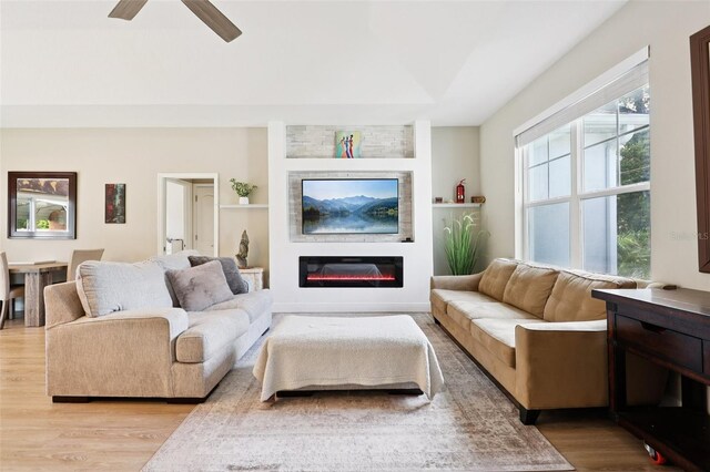 430 Baker Ave, Lake Helen, FL 32744 - living room with light wood-style flooring, a ceiling fan, and a glass covered fireplace