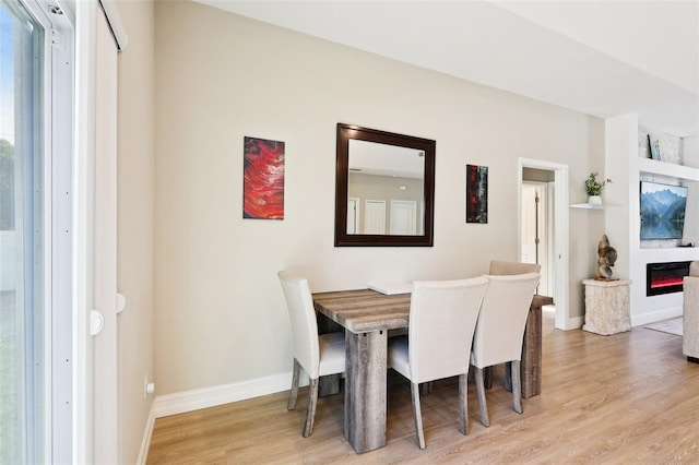 430 Baker Ave, Lake Helen, FL 32744 - dining space featuring light wood-type flooring and a glass covered fireplace