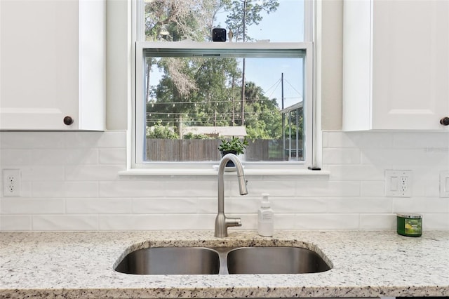 430 Baker Ave, Lake Helen, FL 32744 - kitchen featuring white cabinetry, light stone countertops, and tasteful backsplash
