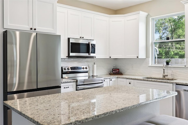 430 Baker Ave, Lake Helen, FL 32744 - kitchen featuring stainless steel appliances, tasteful backsplash, white cabinets, and light stone countertops