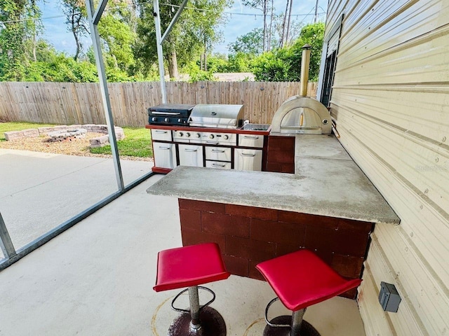 430 Baker Ave, Lake Helen, FL 32744 - fenced backyard with an outdoor kitchen and a patio