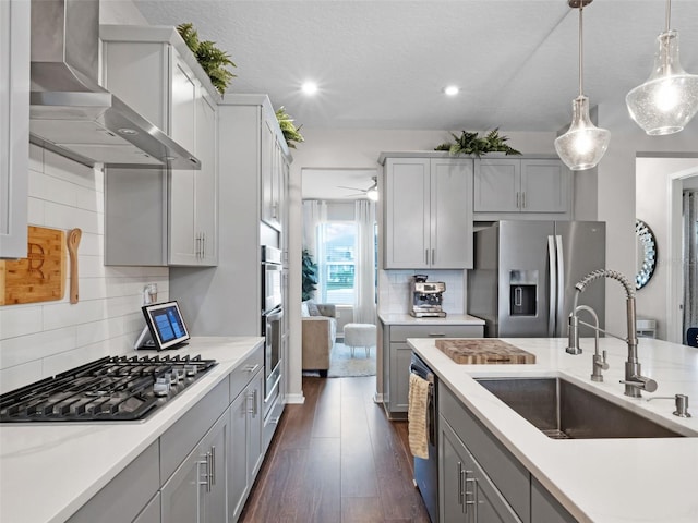 14903 Ellingsworth Ln, Winter Garden, FL 34787 - kitchen with appliances with stainless steel finishes, wall chimney range hood, gray cabinets, pendant lighting, and recessed lighting