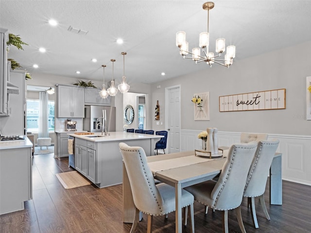 14903 Ellingsworth Ln, Winter Garden, FL 34787 - dining room with recessed lighting, wainscoting, a chandelier, dark wood finished floors, and a decorative wall